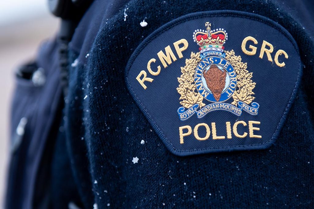 closeup patch of RCMP/GRC police on navy blue uniform