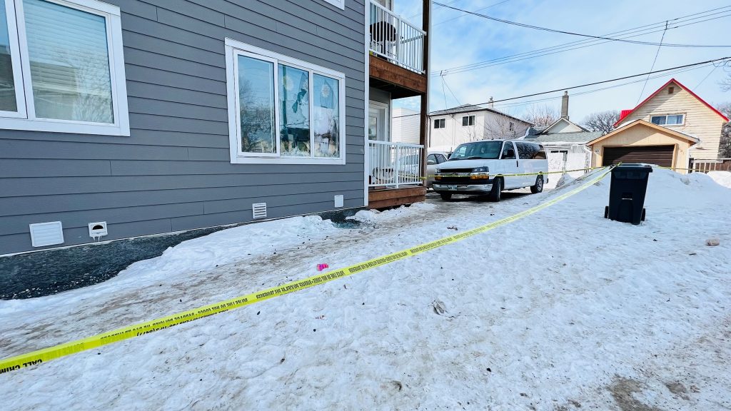 yellow police tape outside Winnipeg home, snow on ground, white van parked