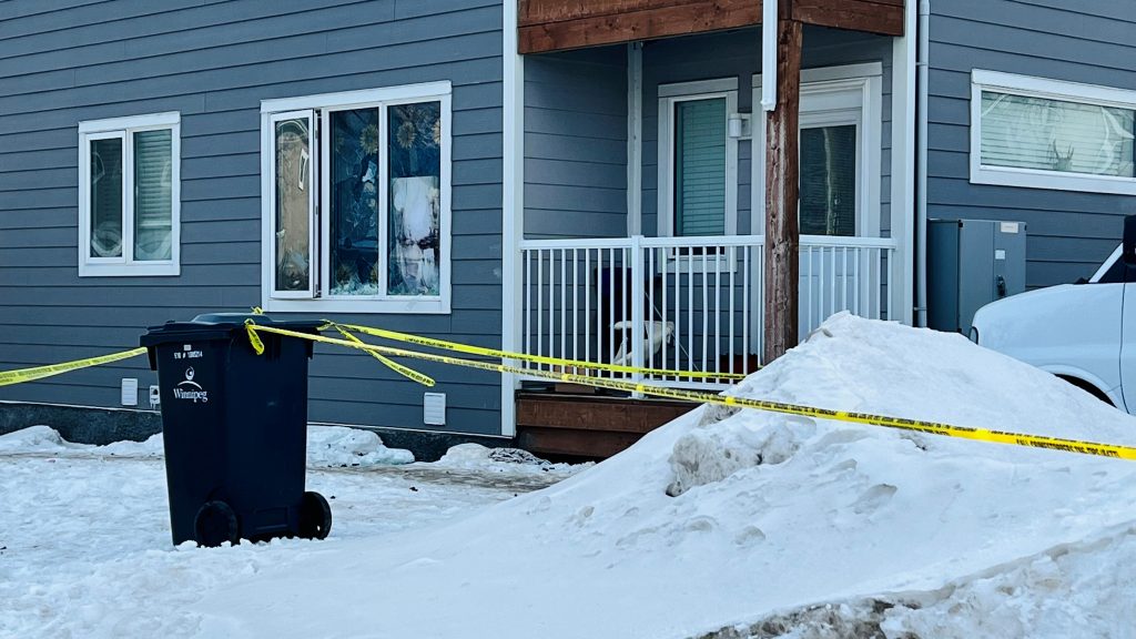 yellow police tape outside Winnipeg home, snow on ground
