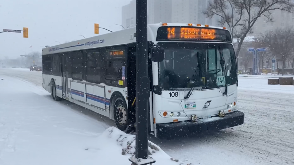 bus waits at stop on snowy day