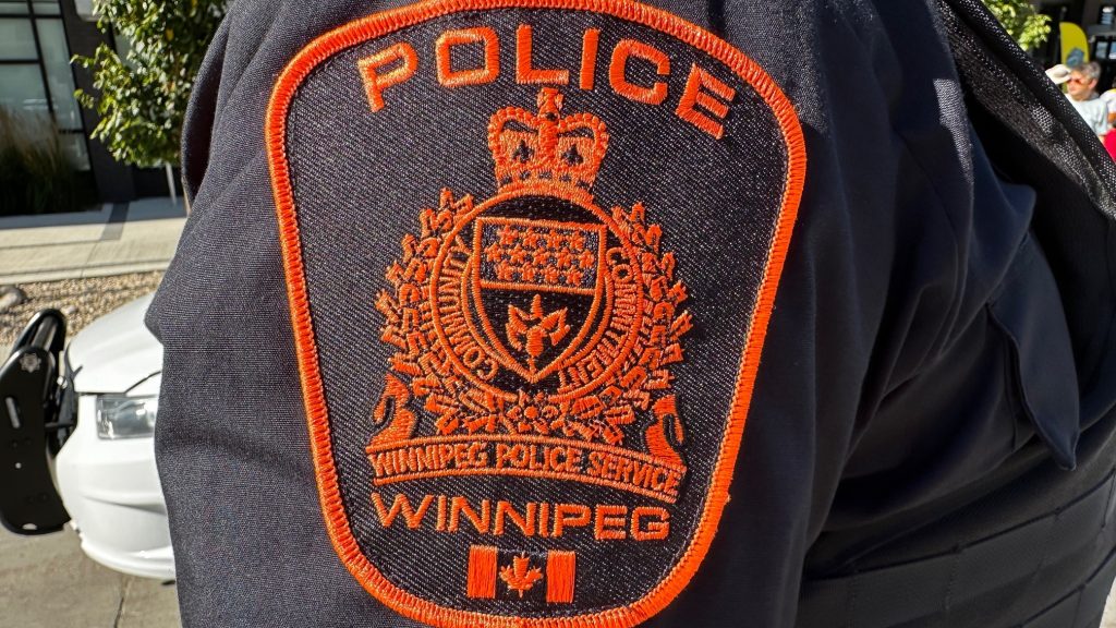 orange Winnipeg police badge