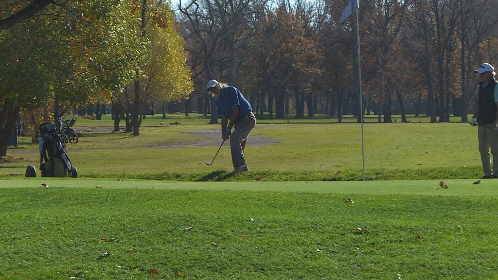 Golfer taking a swing.